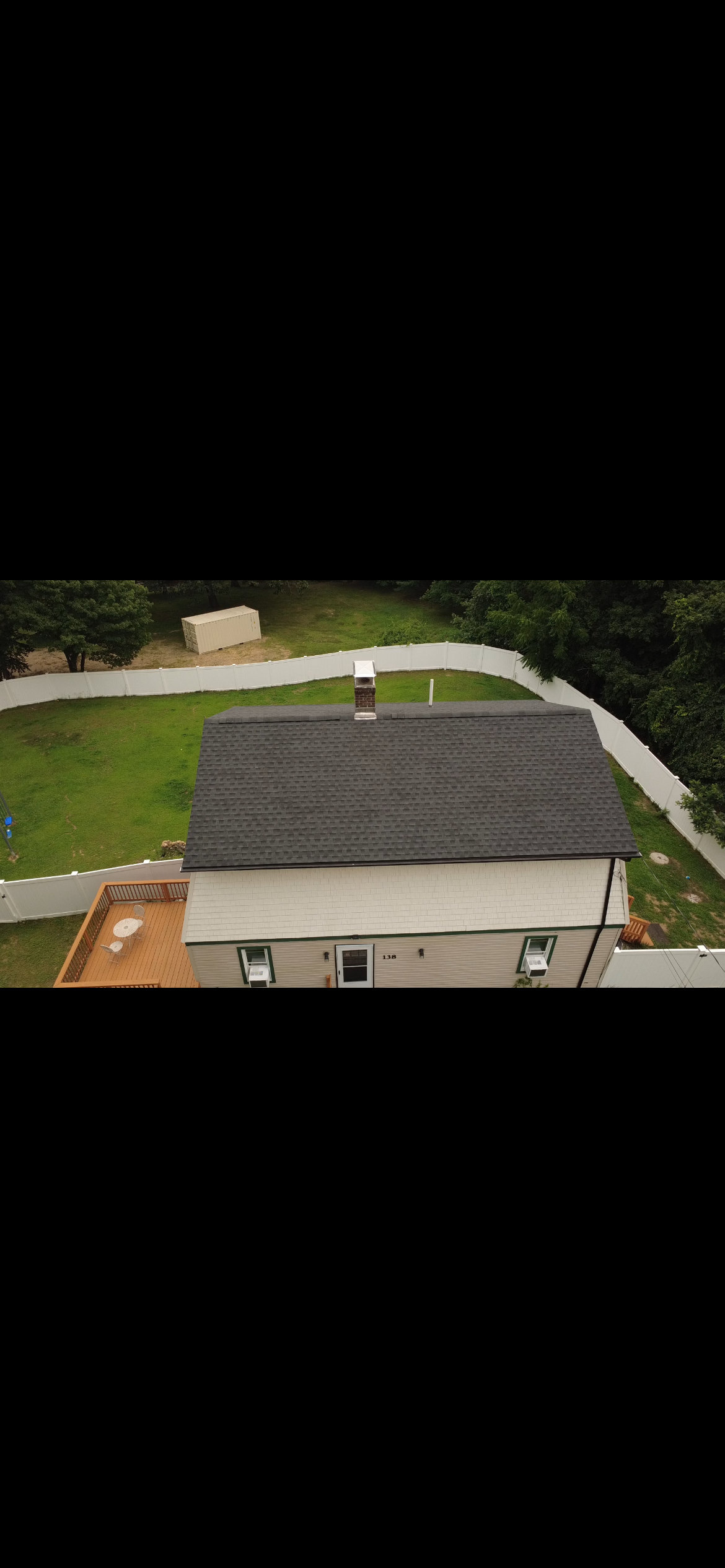 Ranch home with a new charcoal architectural shingle roof seen from above