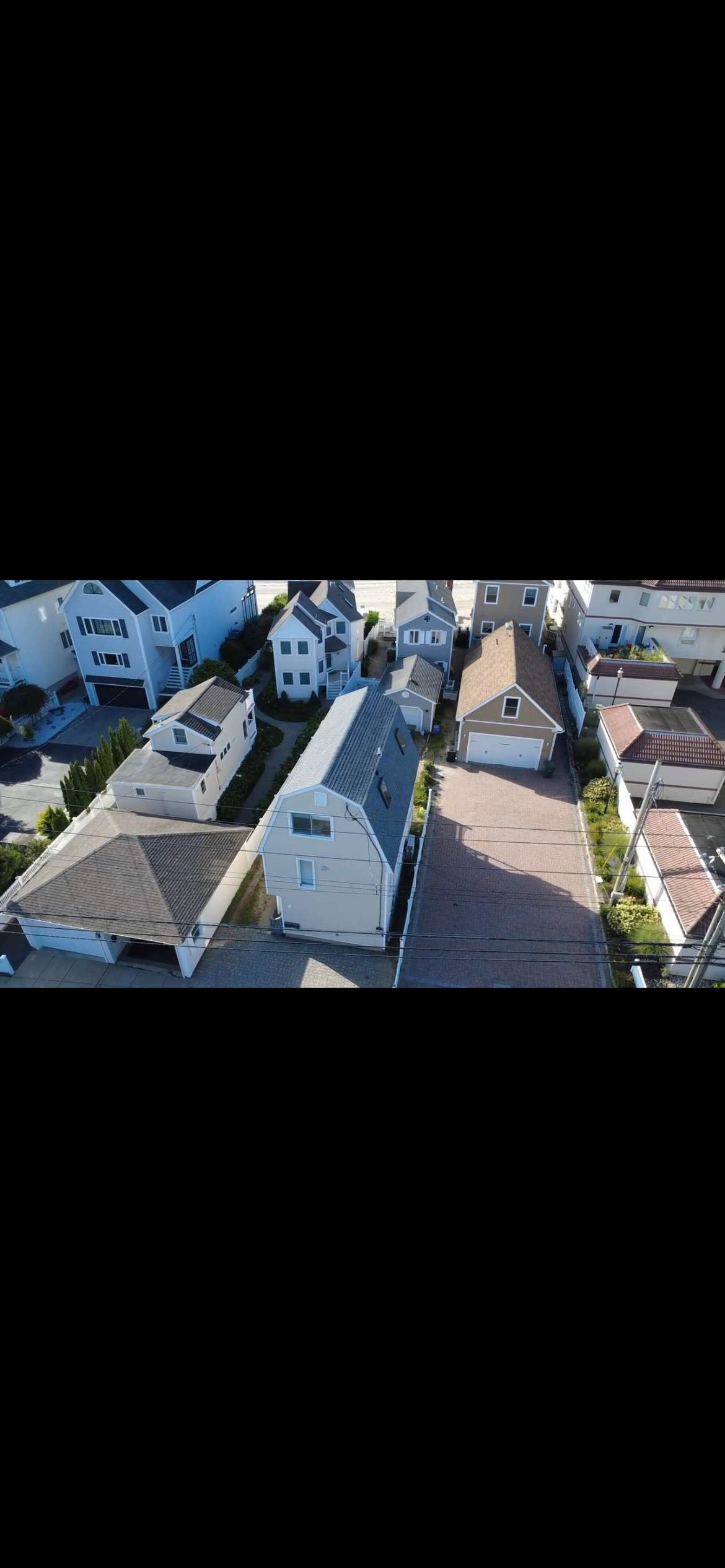 Row of homes in a tight neighborhood after a roof replacement