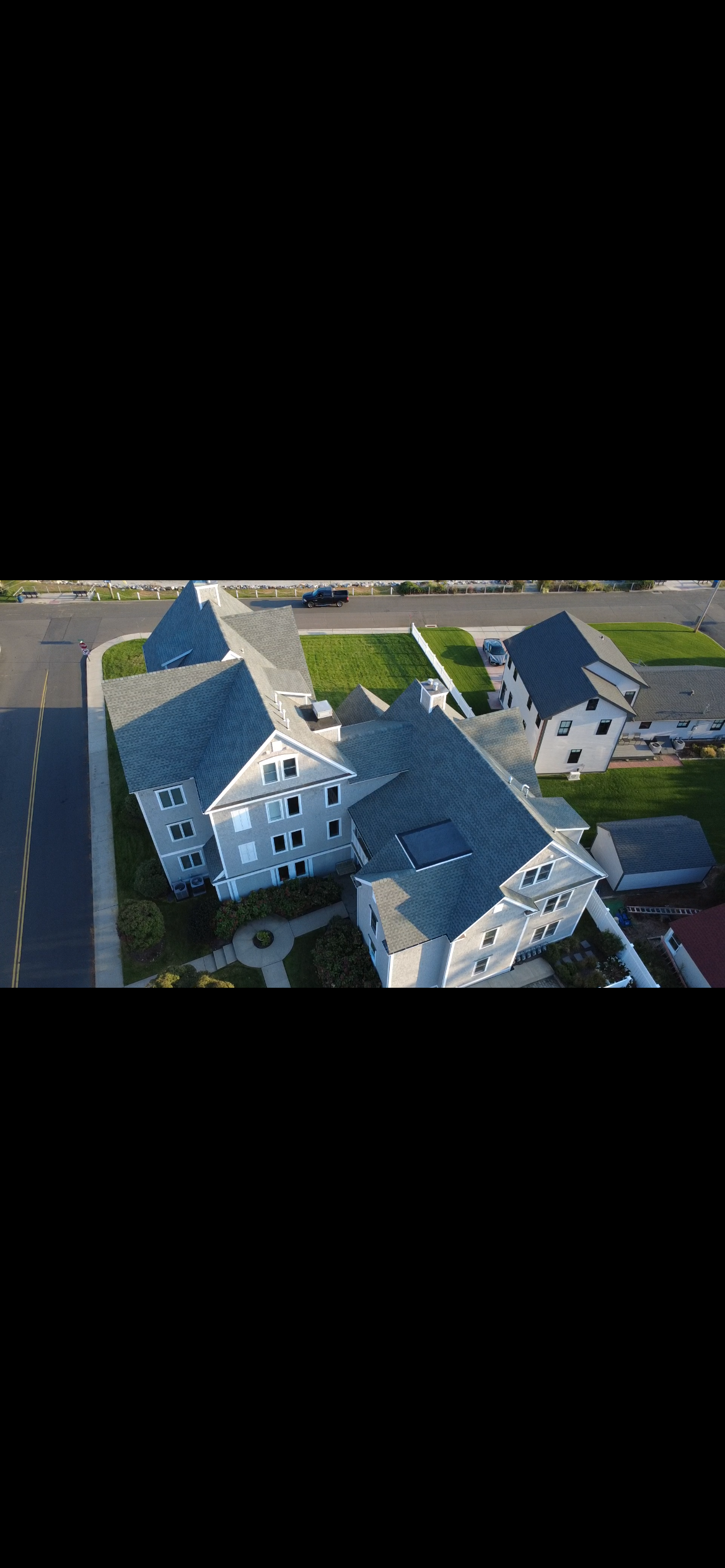 Multi-section roof on a large two-family home, aerial view